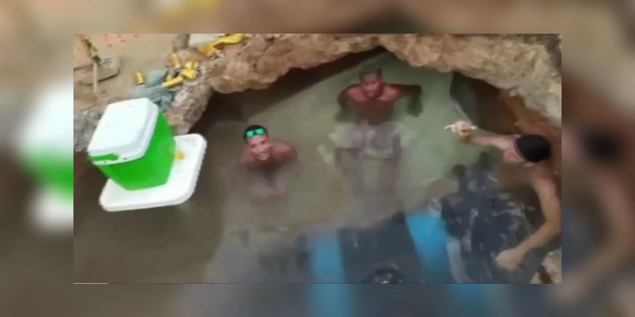 Homens tomam banho e bebem cerveja dentro de buraco de obra, em Belém